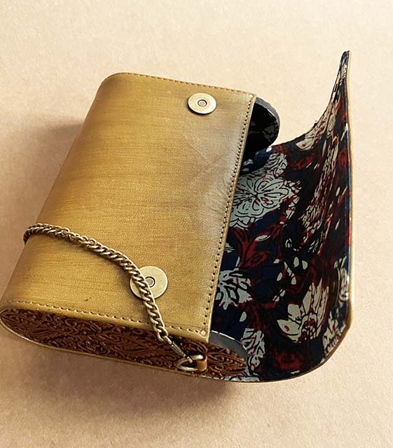 Handfinished carved wood and leather sling bag